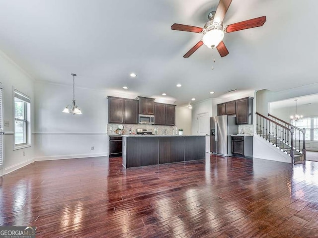 631 Naturewalk Blvd, Dallas, GA 30132 - kitchen with appliances with stainless steel finishes, a chandelier, dark brown cabinets, dark wood-style flooring, and backsplash