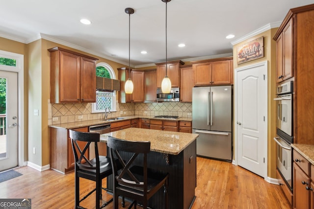 1320 Magnolia Park Cir, Cumming, GA 30040 - kitchen with appliances with stainless steel finishes, brown cabinets, healthy amount of natural light, ornamental molding, and recessed lighting