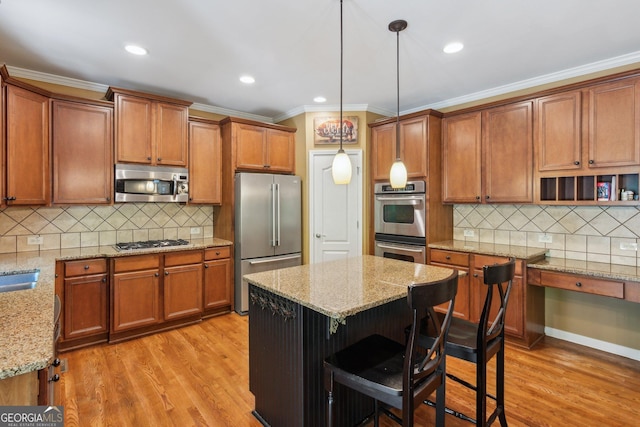 1320 Magnolia Park Cir, Cumming, GA 30040 - kitchen featuring appliances with stainless steel finishes, backsplash, brown cabinetry, crown molding, and recessed lighting