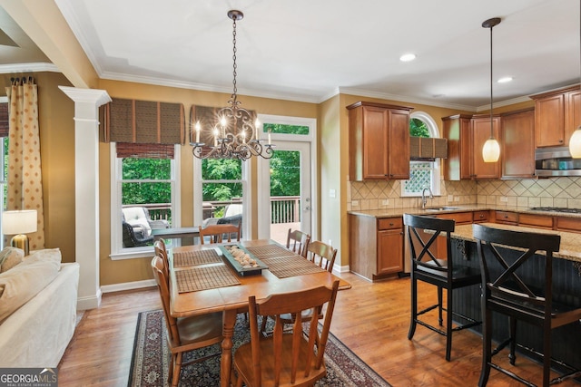 1320 Magnolia Park Cir, Cumming, GA 30040 - dining space with a chandelier, healthy amount of natural light, light wood-style flooring, ornamental molding, and recessed lighting