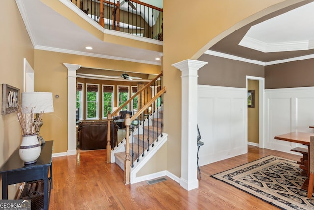 1320 Magnolia Park Cir, Cumming, GA 30040 - entryway with ornate columns, ceiling fan, wood finished floors, arched walkways, and stairway