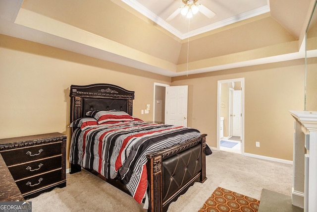 bedroom featuring a tray ceiling, light carpet, crown molding, connected bathroom, and baseboards