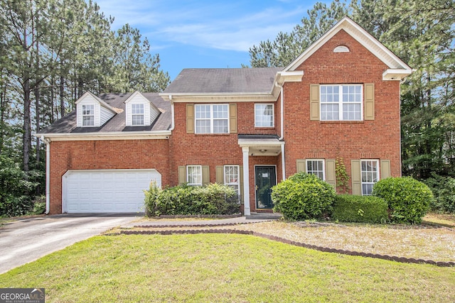 view of front of property featuring driveway, a front yard, an attached garage, and brick siding