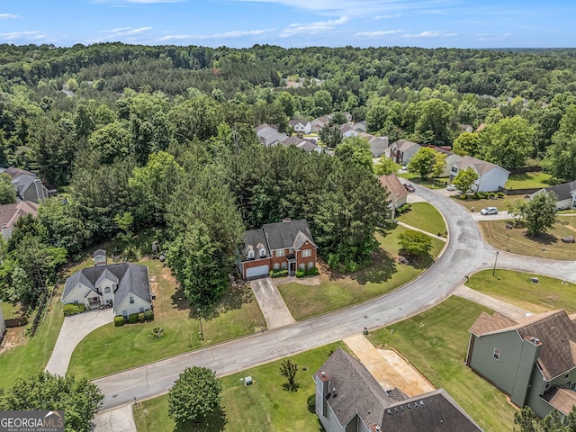 aerial overview of property's location with a forest and nearby suburban area