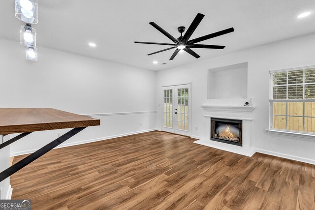 2849 Windsor Forrest Ct, Atlanta, GA 30349 - unfurnished living room with wood finished floors, a ceiling fan, a warm lit fireplace, plenty of natural light, and recessed lighting