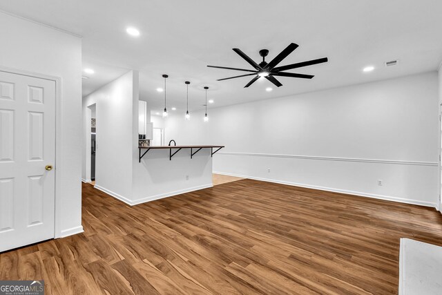 2849 Windsor Forrest Ct, Atlanta, GA 30349 - unfurnished living room with ceiling fan, baseboards, recessed lighting, and wood finished floors