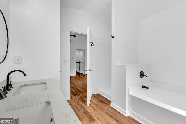 2849 Windsor Forrest Ct, Atlanta, GA 30349 - full bathroom featuring a bath, wood finished floors, double vanity, and baseboards