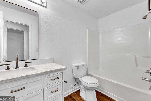 2849 Windsor Forrest Ct, Atlanta, GA 30349 - full bathroom featuring vanity, toilet, wood finished floors, shower / bath combination, and baseboards