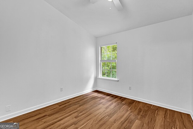 2849 Windsor Forrest Ct, Atlanta, GA 30349 - unfurnished room featuring lofted ceiling, a ceiling fan, wood finished floors, and baseboards