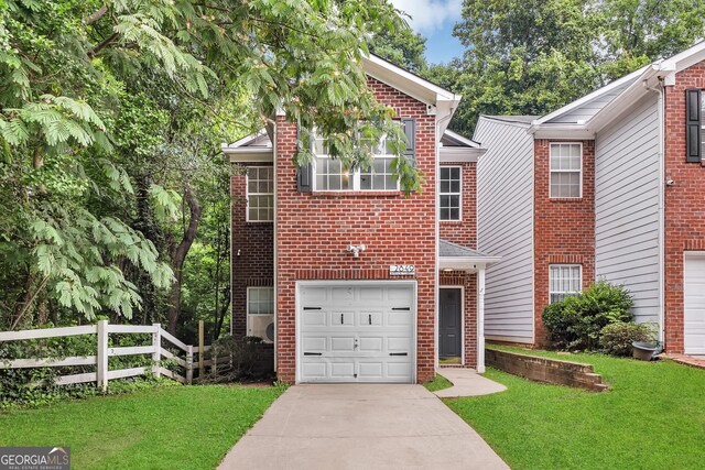 2849 Windsor Forrest Ct, Atlanta, GA 30349 - view of front of property featuring brick siding, an attached garage, and concrete driveway