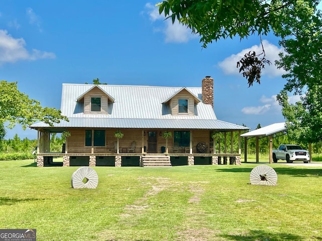 570 July Rd, Rochelle, GA 31079 - view of front facade with a porch, a front lawn, a chimney, and metal roof