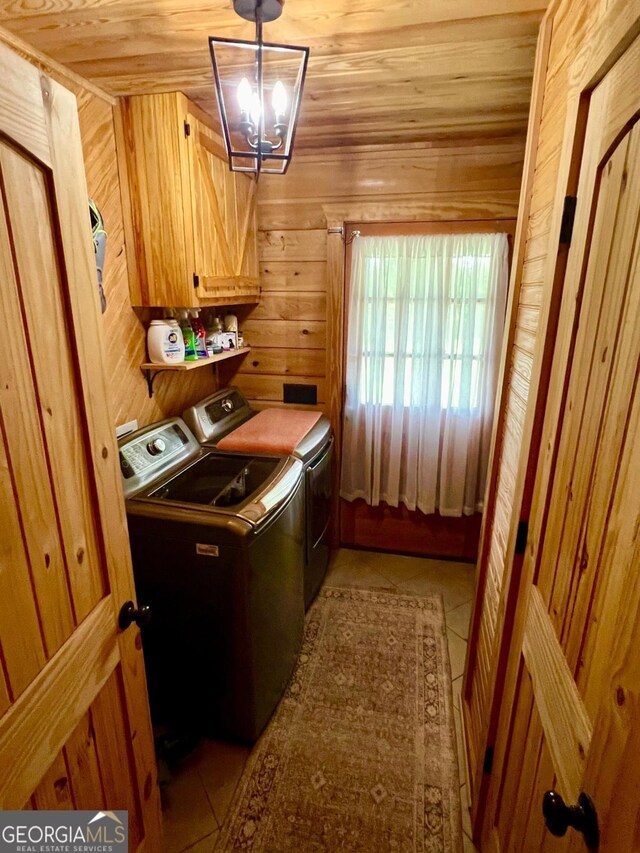 570 July Rd, Rochelle, GA 31079 - washroom featuring cabinet space, separate washer and dryer, tile patterned floors, wood walls, and a chandelier
