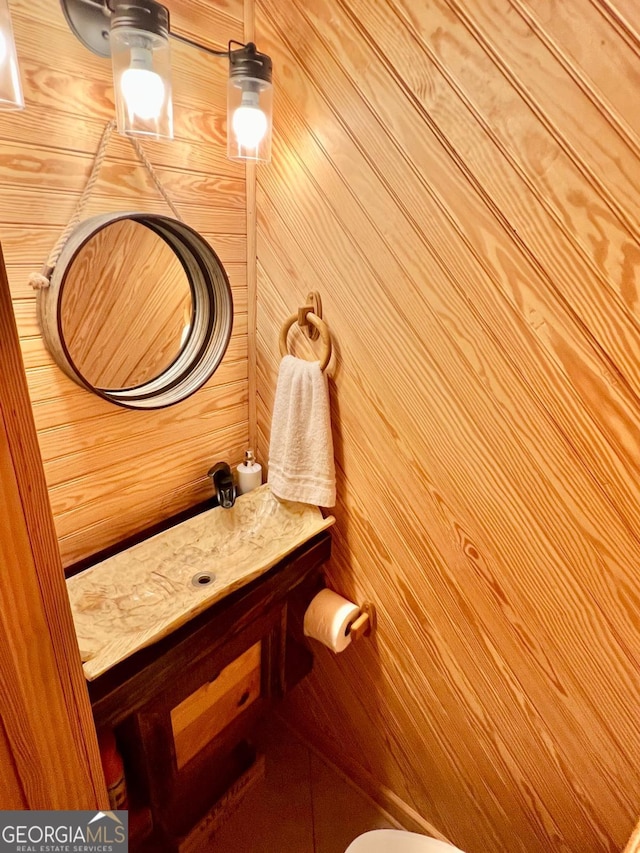 570 July Rd, Rochelle, GA 31079 - half bath featuring vanity and wood walls