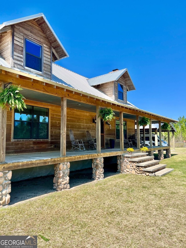 570 July Rd, Rochelle, GA 31079 - view of side of home with a lawn and metal roof