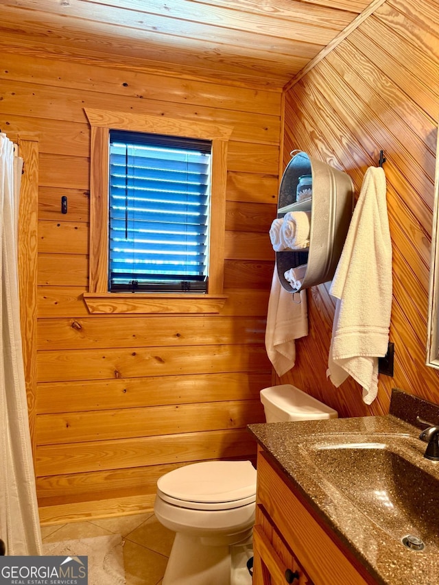 570 July Rd, Rochelle, GA 31079 - bathroom featuring vanity, toilet, tile patterned flooring, and wooden walls