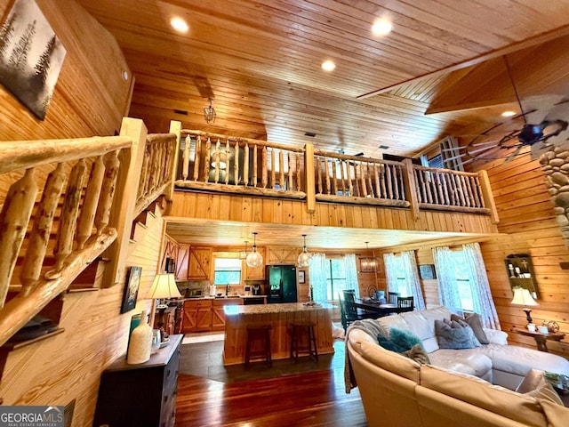 570 July Rd, Rochelle, GA 31079 - living room with a towering ceiling, wooden walls, dark wood-style floors, wood ceiling, and recessed lighting