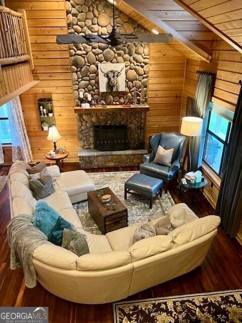 570 July Rd, Rochelle, GA 31079 - living area with hardwood / wood-style flooring, wood walls, wooden ceiling, and a stone fireplace