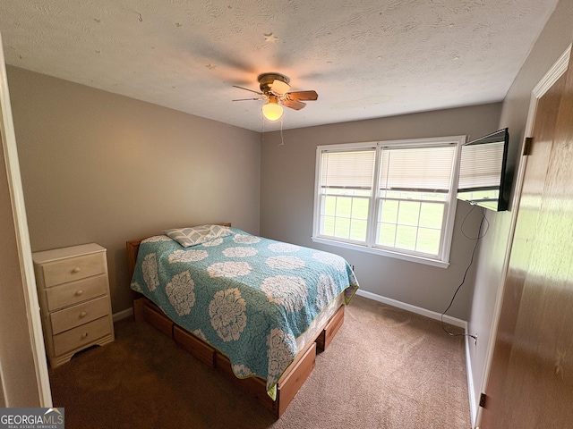 carpeted bedroom featuring baseboards and ceiling fan