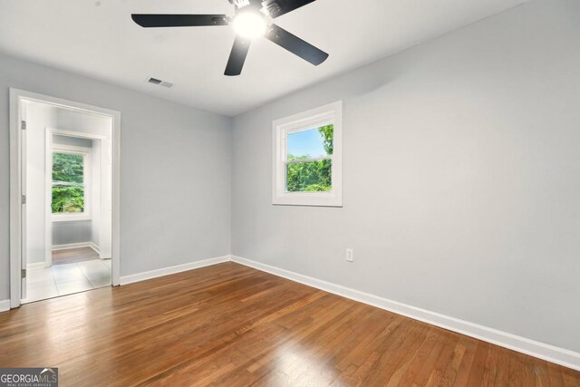 163 Oakcliff Ct, Atlanta, GA 30331 - spare room with baseboards, healthy amount of natural light, wood finished floors, and ceiling fan