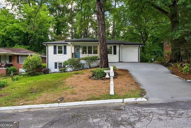 163 Oakcliff Ct, Atlanta, GA 30331 - view of front of property featuring asphalt driveway, a porch, and view of scattered trees