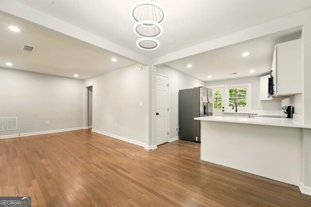 163 Oakcliff Ct, Atlanta, GA 30331 - unfurnished living room with wood finished floors, a sink, recessed lighting, and baseboards