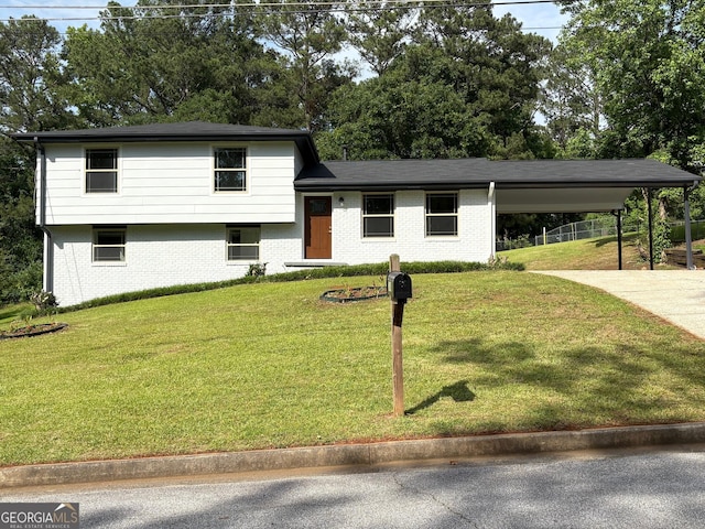 7340 Chalk Way, Riverdale, GA 30296 - tri-level home with brick siding, concrete driveway, a front yard, and an attached carport