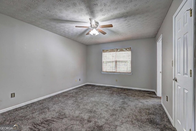 carpeted empty room with a ceiling fan, a textured ceiling, and baseboards