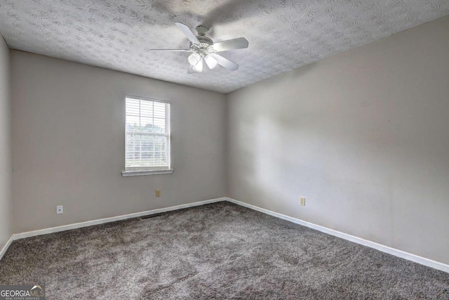 empty room with carpet, ceiling fan, a textured ceiling, and baseboards