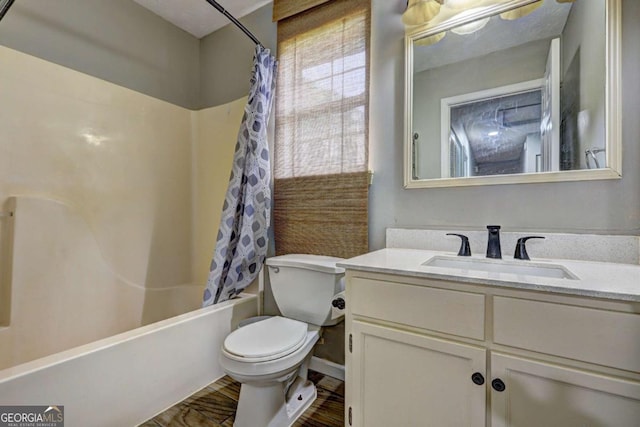bathroom featuring toilet, vanity, shower / tub combo, and wood finished floors