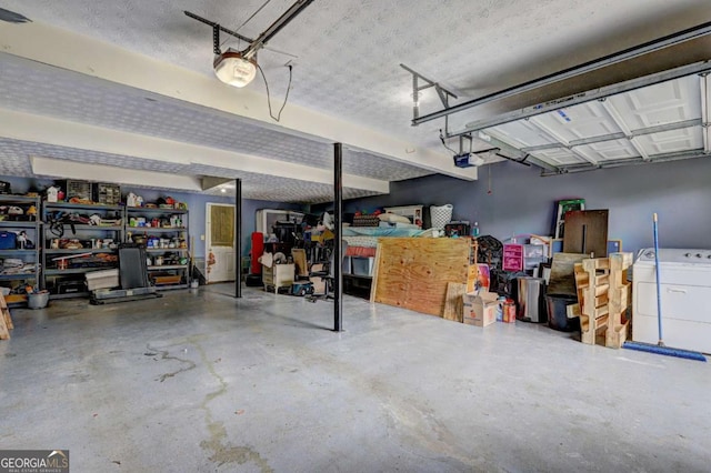 garage with washer / dryer and a garage door opener