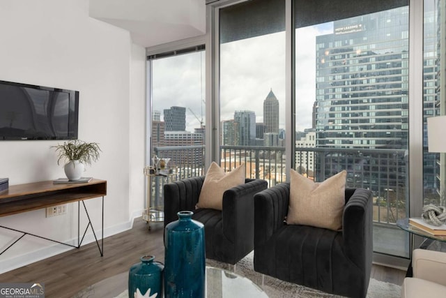 855 Peachtree St NE Unit 1508, Atlanta, GA 30308 - living room with wood finished floors, a view of city, expansive windows, and baseboards