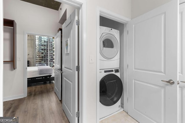 855 Peachtree St NE Unit 1508, Atlanta, GA 30308 - laundry area with stacked washer / dryer and light wood-type flooring