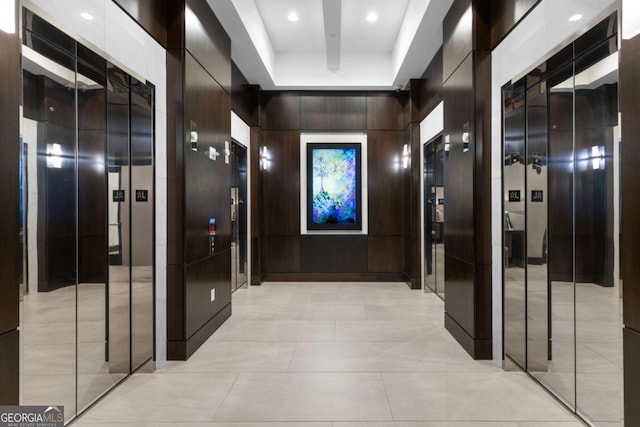 855 Peachtree St NE Unit 1508, Atlanta, GA 30308 - corridor featuring elevator, a raised ceiling, light tile patterned floors, wood walls, and recessed lighting