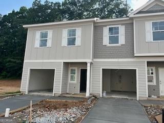 4261 Notting Hill Dr SW, Atlanta, GA 30331 - view of front facade with driveway, an attached garage, and board and batten siding