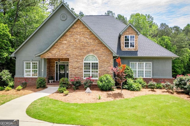 319 Stonebridge Blvd, Bremen, GA 30110 - view of front of house with a front yard, stucco siding, roof with shingles, and brick siding