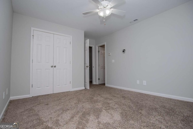 319 Stonebridge Blvd, Bremen, GA 30110 - unfurnished bedroom with carpet flooring, a closet, baseboards, and a ceiling fan