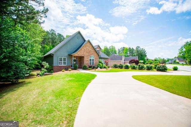 319 Stonebridge Blvd, Bremen, GA 30110 - view of front facade featuring brick siding, a front yard, and curved driveway