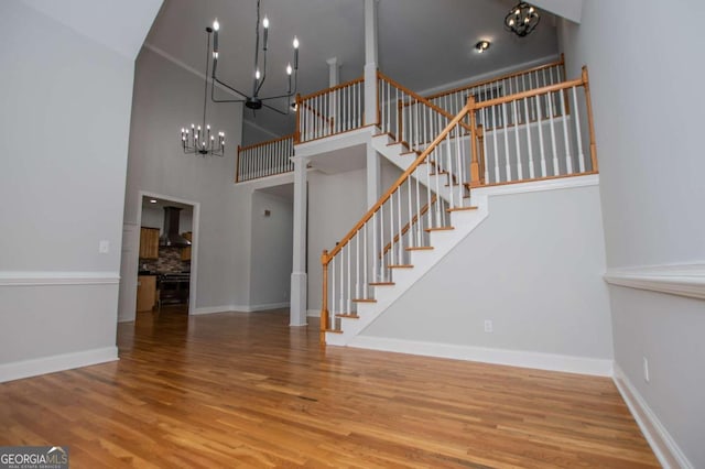 319 Stonebridge Blvd, Bremen, GA 30110 - staircase featuring a chandelier, wood finished floors, baseboards, and a high ceiling