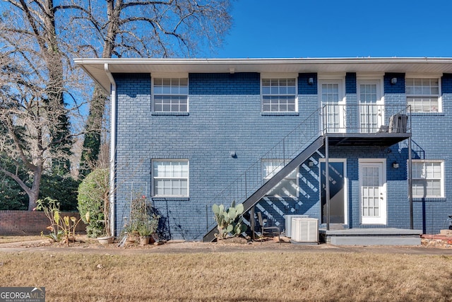 3137 Buford Hwy NE Unit 11, Brookhaven, GA 30329 - back of property with central air condition unit, brick siding, and stairway