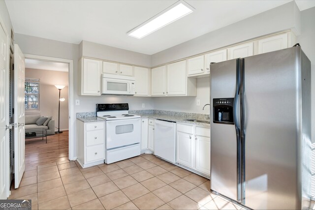 3137 Buford Hwy NE Unit 11, Brookhaven, GA 30329 - kitchen with white appliances, a sink, white cabinetry, and light stone countertops