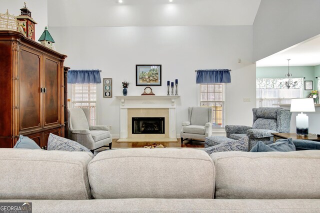 315 Antebellum Way, Fayetteville, GA 30215 - living area featuring a fireplace with raised hearth, a chandelier, and wood finished floors