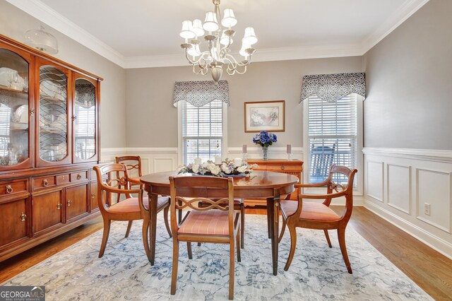 315 Antebellum Way, Fayetteville, GA 30215 - dining room with a chandelier, wood finished floors, a wainscoted wall, crown molding, and a decorative wall