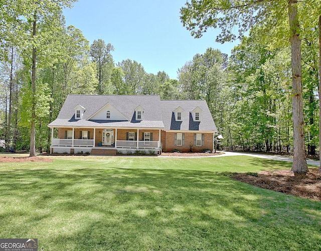 315 Antebellum Way, Fayetteville, GA 30215 - cape cod home featuring a porch, brick siding, and a front lawn