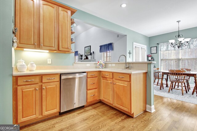 315 Antebellum Way, Fayetteville, GA 30215 - kitchen with stainless steel dishwasher, a peninsula, light wood-style flooring, a sink, and a chandelier
