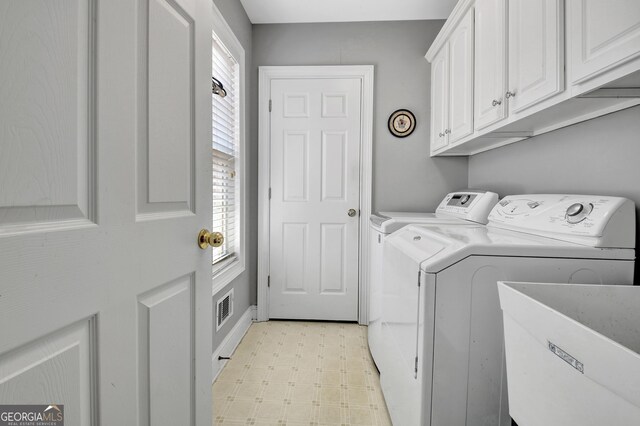 315 Antebellum Way, Fayetteville, GA 30215 - clothes washing area with washing machine and dryer, light flooring, and cabinet space