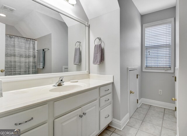 315 Antebellum Way, Fayetteville, GA 30215 - bathroom featuring vaulted ceiling, tile patterned flooring, vanity, and baseboards