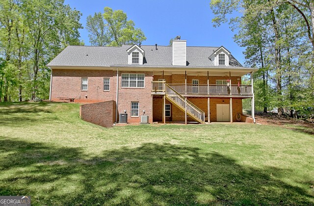 315 Antebellum Way, Fayetteville, GA 30215 - rear view of property featuring stairs, a deck, a chimney, brick siding, and a yard