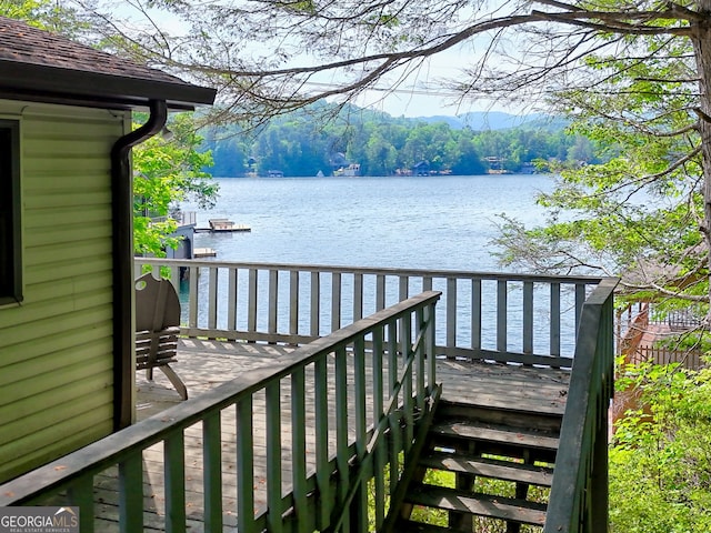 wooden terrace featuring a water view