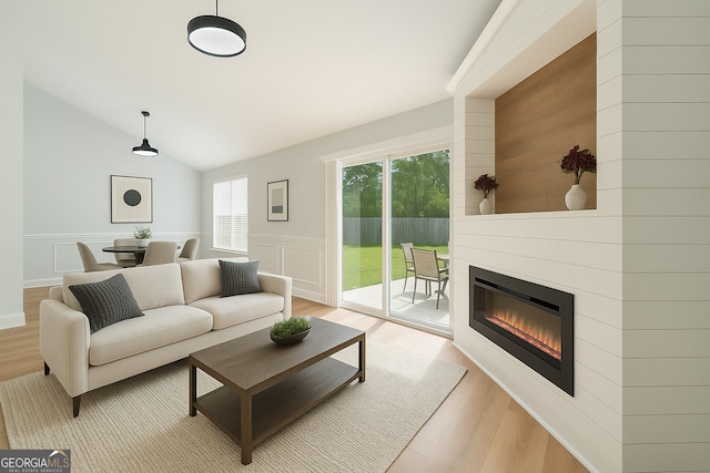 162 W Tahoe Dr, Savannah, GA 31405 - living area with light wood-style floors, a fireplace, wainscoting, vaulted ceiling, and a decorative wall