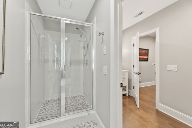 6815 Berkley Rd, Cumming, GA 30040 - bathroom with a shower stall, baseboards, and wood finished floors